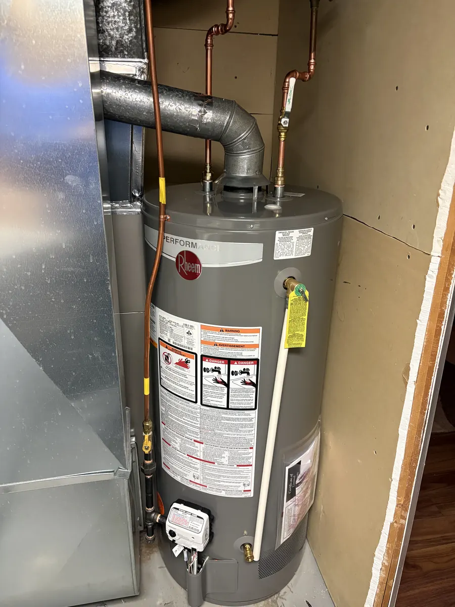 New gas tank water heater installed with copper supply lines and venting