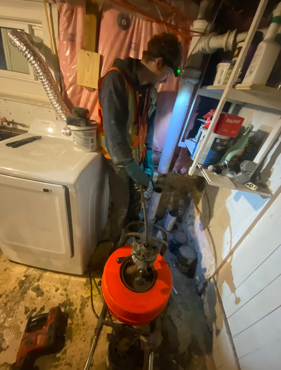 Panacci plumber snaking a clogged basement laundry drain